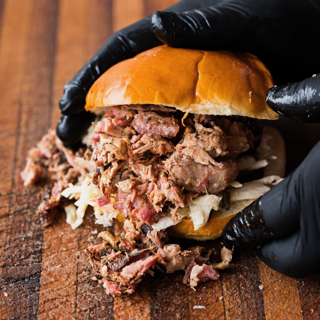 Pulled Pork BBQ sandwich with barbecue pork overflowing from the bun.