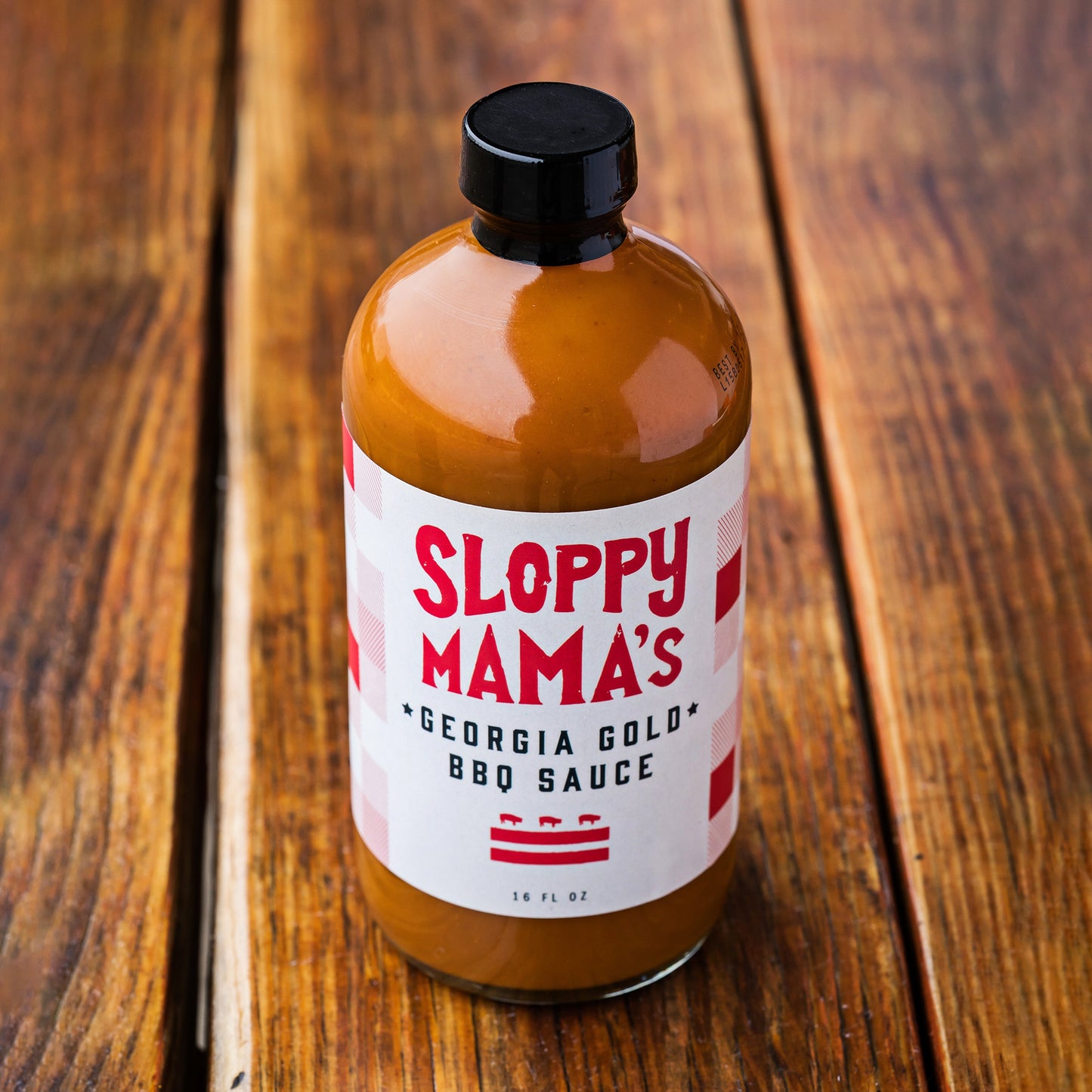 16 oz bottle Sloppy Mama's BBQ Georgia Gold BBQ Sauce. A Mustard-based barbecue sauce.